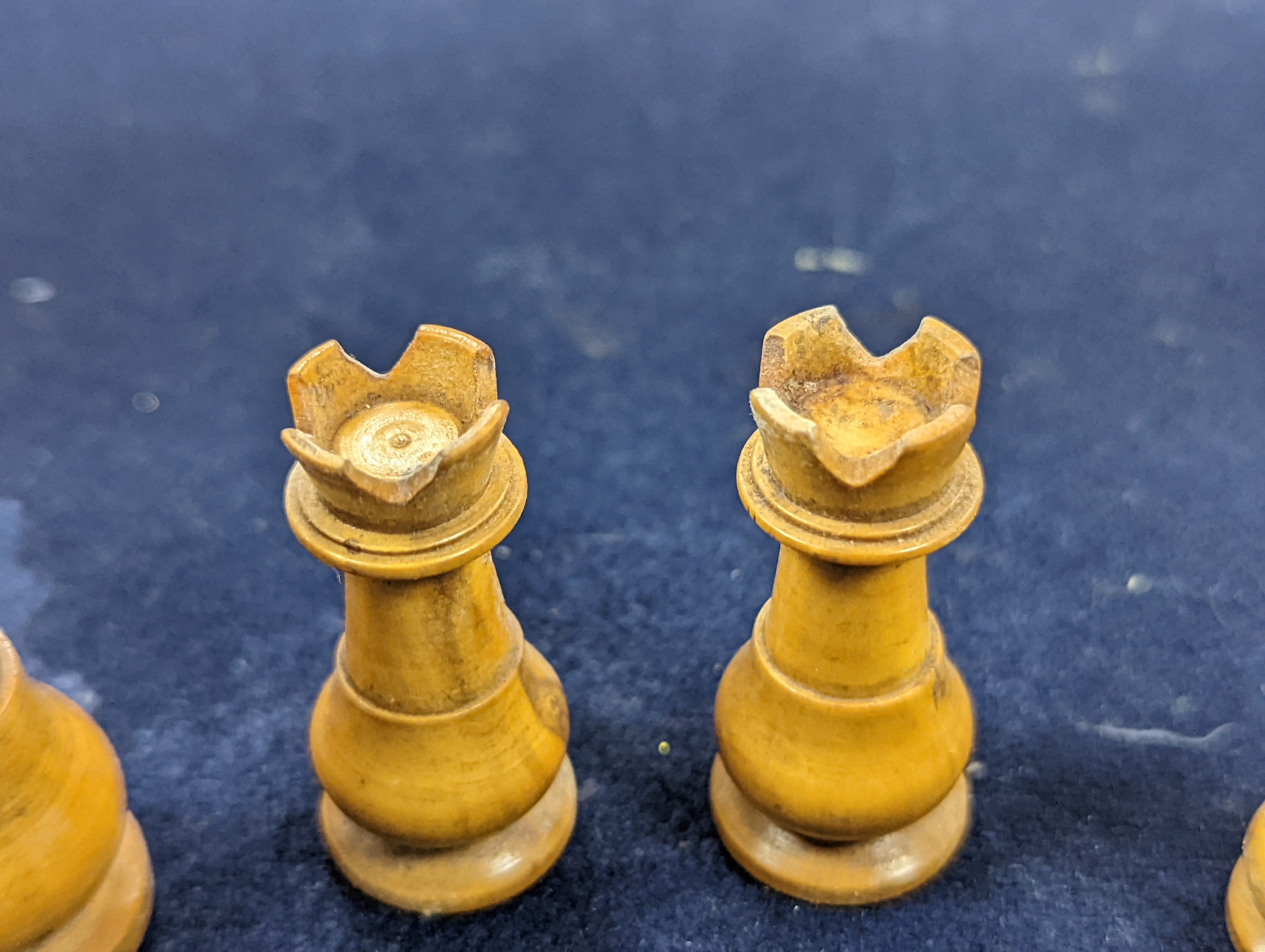 A Victorian brass inset mahogany games box, fitted with solitaire, cribbage, chessmen, draughts etc., 33cm, a turned and stained bone chess set, another games box containing chessmen and draughts